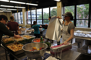 Students prepping food in Campus Kitchen workspace