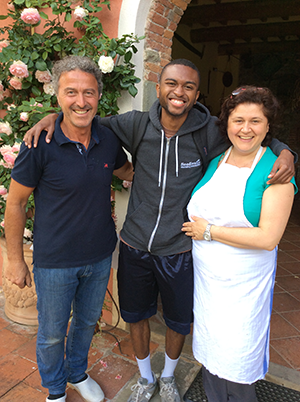 Jevincio Tooson is pictured with a family who hosted the students at their home and organic farm in Lucca, Italy.