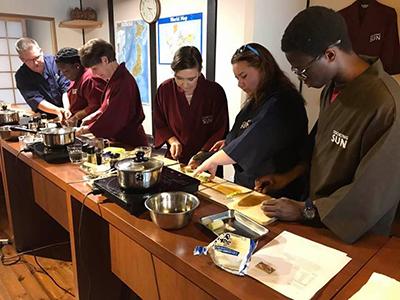 Bob Perry and students in cooking class