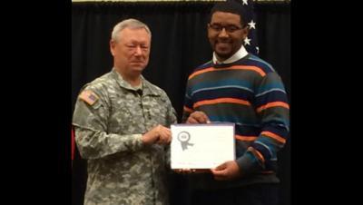 Gen. Frank Grass presents Tyrone Atkinson with the Youth Development Volunteer Award. 