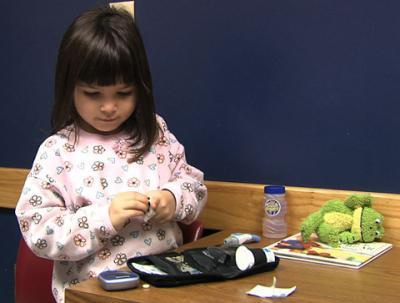 Child with diabetic testing kit