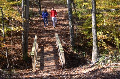 Local business owners Kerri and Al Barman walk along the nature trail they designed and cleared. 