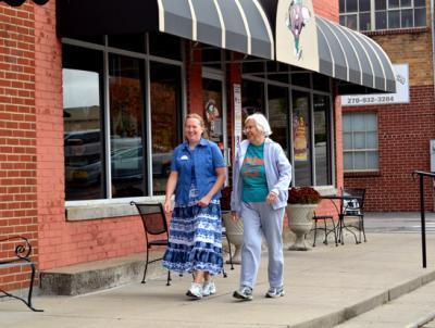 Missy Curry, left, and Suzanne Taylor walk on Greensburg's Merchant Mile. 